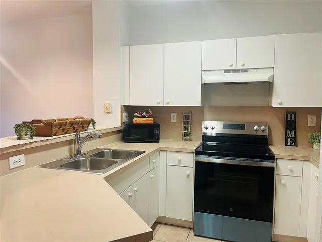 a kitchen with cabinets and stainless steel appliances