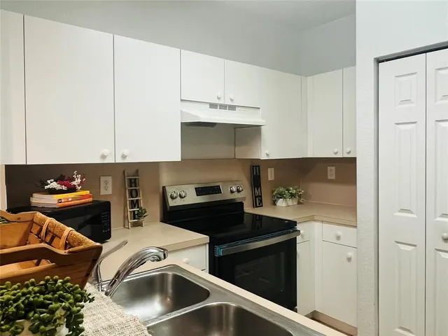 a kitchen with stainless steel appliances granite countertop a stove and a refrigerator