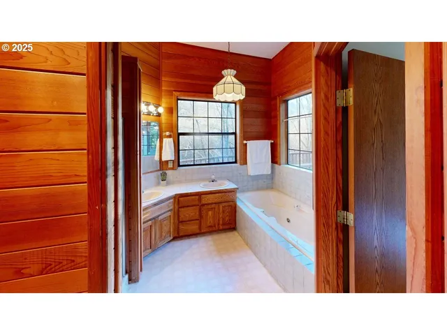 a bathroom with a tub and a view of bathroom