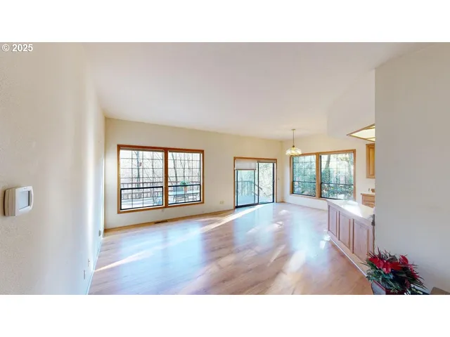 a open hall with wooden floor and windows