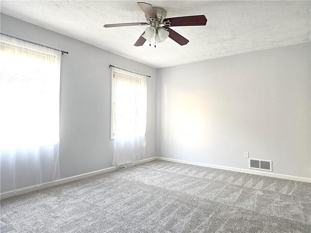 316 Stein Road Chicora, PA 16025 - Photo 23 of 41 an empty room with windows and fan