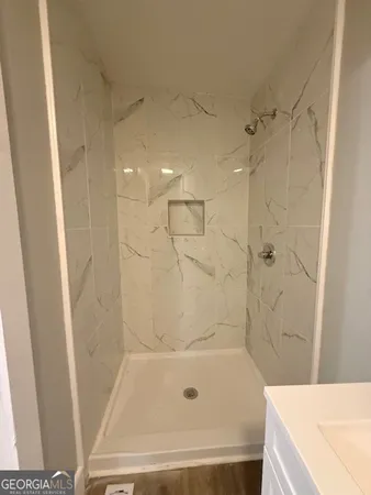 a bathroom with a bathtub and a shower