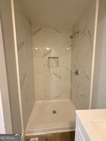 a bathroom with a bathtub and a shower