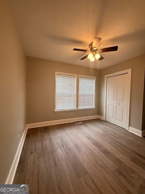 443 Stewart Street Southwest Pelham, GA 31779 - Photo 19 of 19 a view of an empty room with window and wooden floor