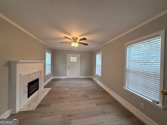 a view of empty room with fireplace and fan