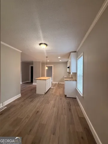 a view of a living room with a sink and dishwasher