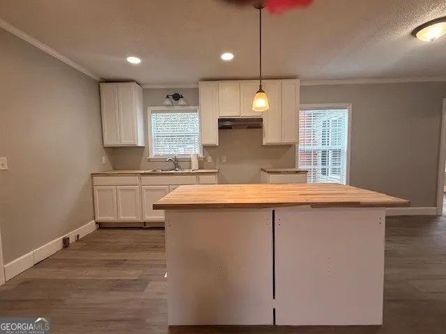 a kitchen with kitchen island a sink stainless steel appliances and window