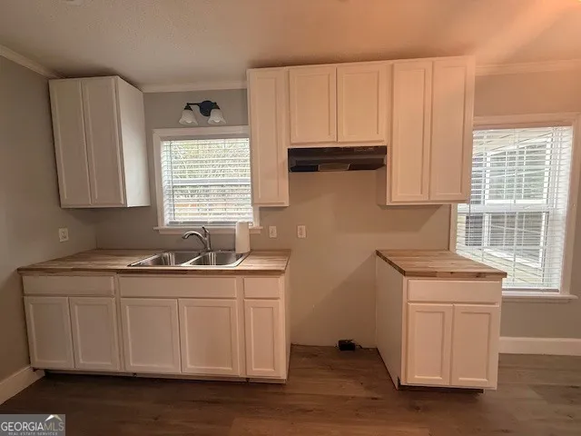 a kitchen with stainless steel appliances granite countertop a sink stove and cabinets