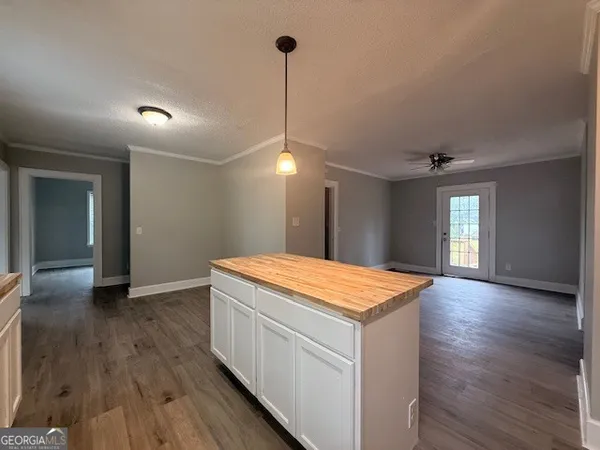 a hall with wooden floor and a chandelier