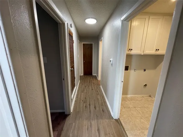a view of hallway with wooden floor