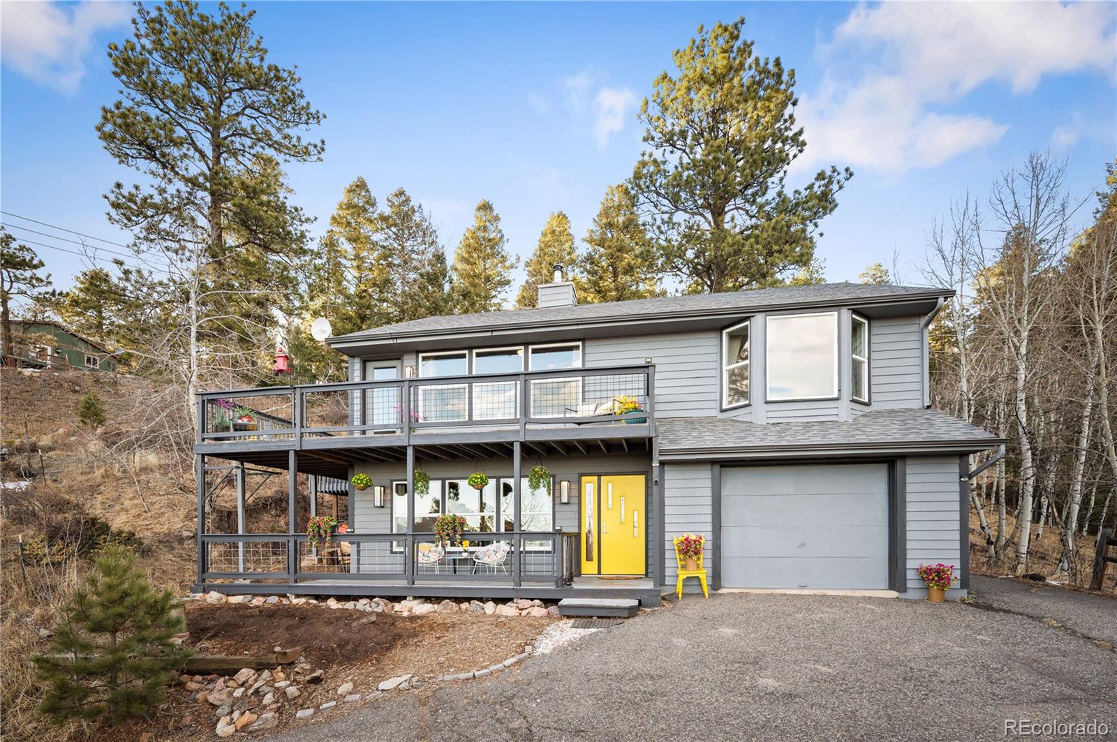 11740 Baca Road Conifer, CO 80433 - Photo 4 of 49 a view of a house with roof deck and a tree