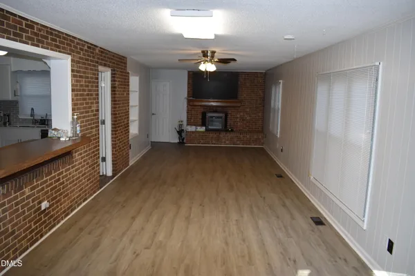 a living room with a fireplace and a flat screen tv