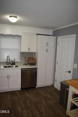 a kitchen with granite countertop a refrigerator and a stove top oven