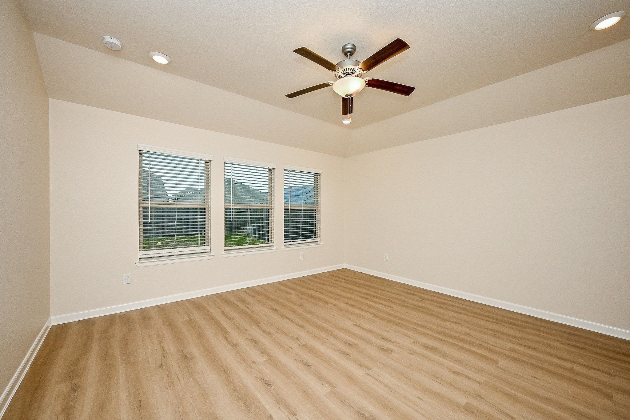 3715 Homestead Ridge Lane Richmond, TX 77406 - Photo 12 of 20 a view of an empty room with wooden floor and a window