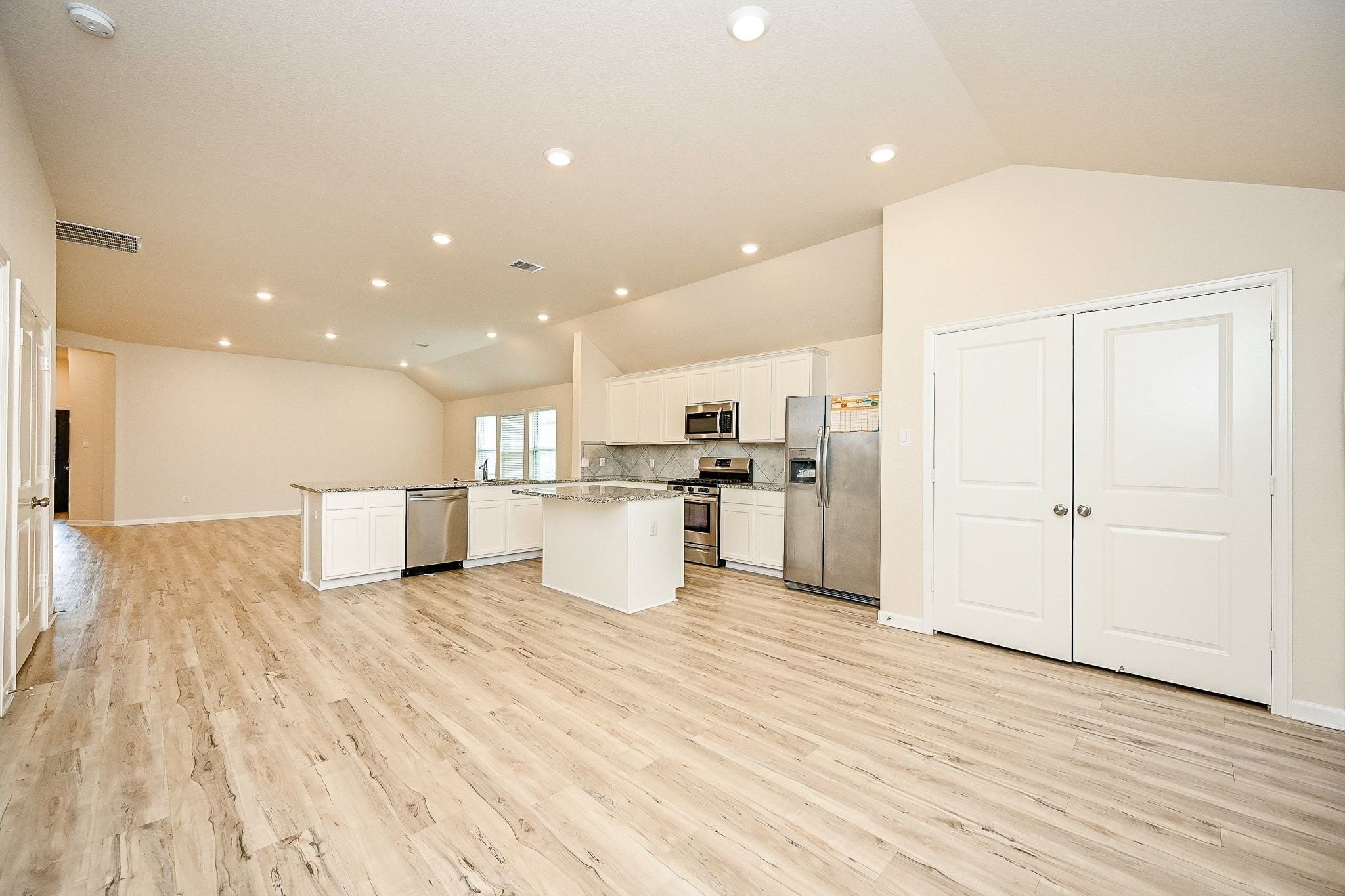 3715 Homestead Ridge Lane Richmond, TX 77406 - Photo 6 of 20 a view of kitchen with kitchen island wooden floors appliances and white cabinets