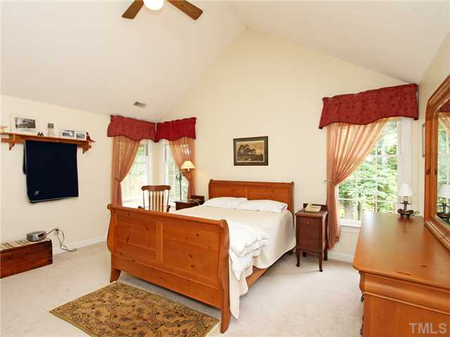 5629 Barham Court Raleigh, NC 27613 - Photo 11 of 17 a bedroom with a bed and a couch