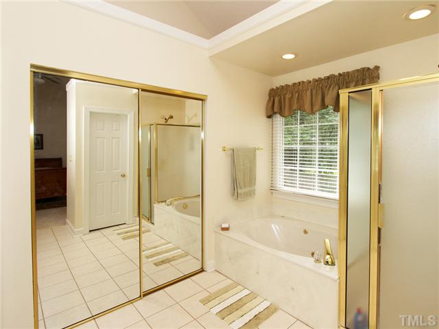 5629 Barham Court Raleigh, NC 27613 - Photo 12 of 17 a bathroom with a glass shower door and a glass door