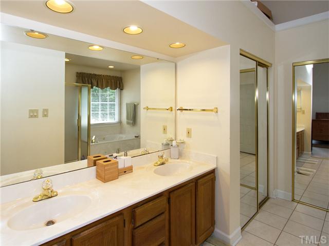 5629 Barham Court Raleigh, NC 27613 - Photo 13 of 17 a bathroom with a sink tub shower and a mirror