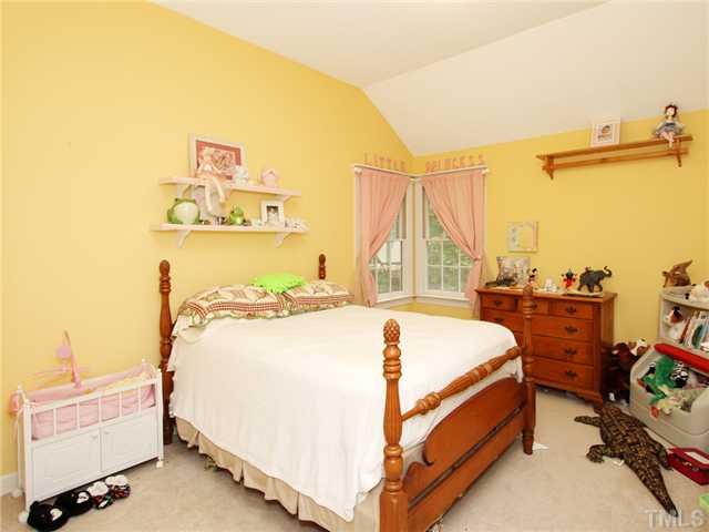 5629 Barham Court Raleigh, NC 27613 - Photo 14 of 17 a bedroom with a bed and a window
