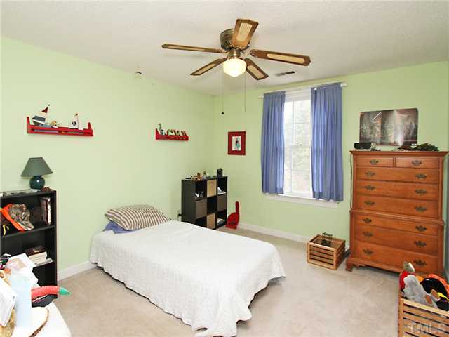 5629 Barham Court Raleigh, NC 27613 - Photo 16 of 17 a bedroom with a bed and a tv