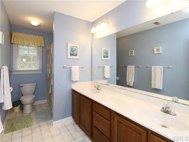 5629 Barham Court Raleigh, NC 27613 - Photo 17 of 17 a bathroom with a sink and a mirror
