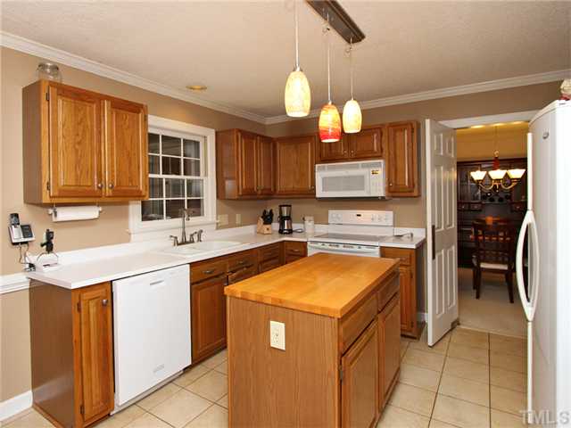 5629 Barham Court Raleigh, NC 27613 - Photo 8 of 17 a kitchen with a sink a counter top space cabinets and stainless steel appliances