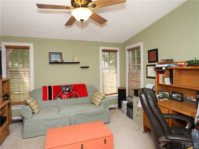 5629 Barham Court Raleigh, NC 27613 - Photo 10 of 17 a living room with furniture and a flat screen tv