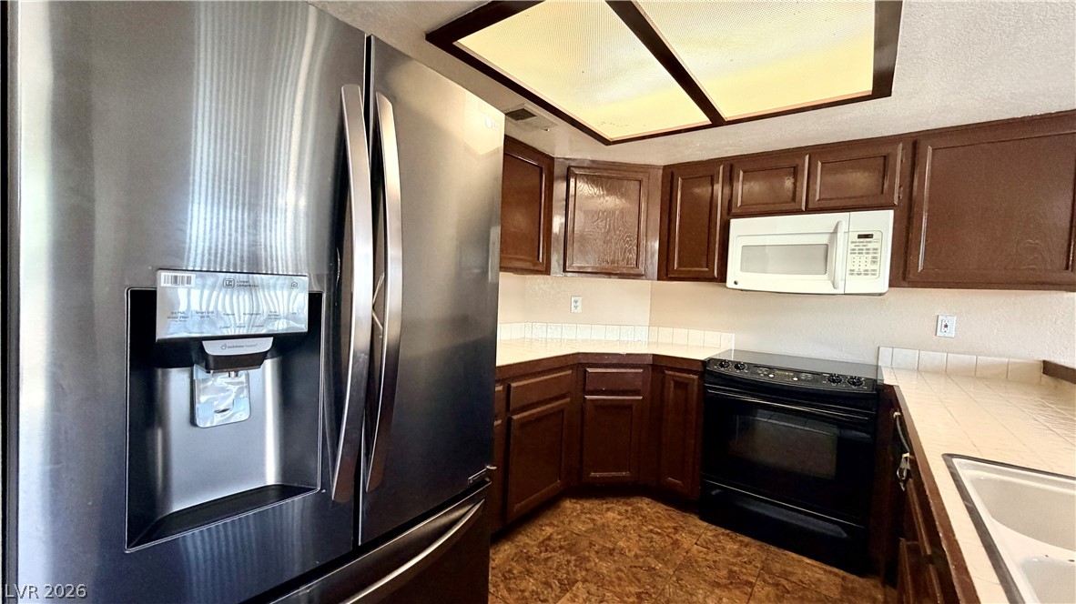 6250 West Flamingo Road, Unit 4 Las Vegas, NV 89103 - Photo 13 of 45 This functional kitchen features ample cabinetry and essential appliances for everyday living.