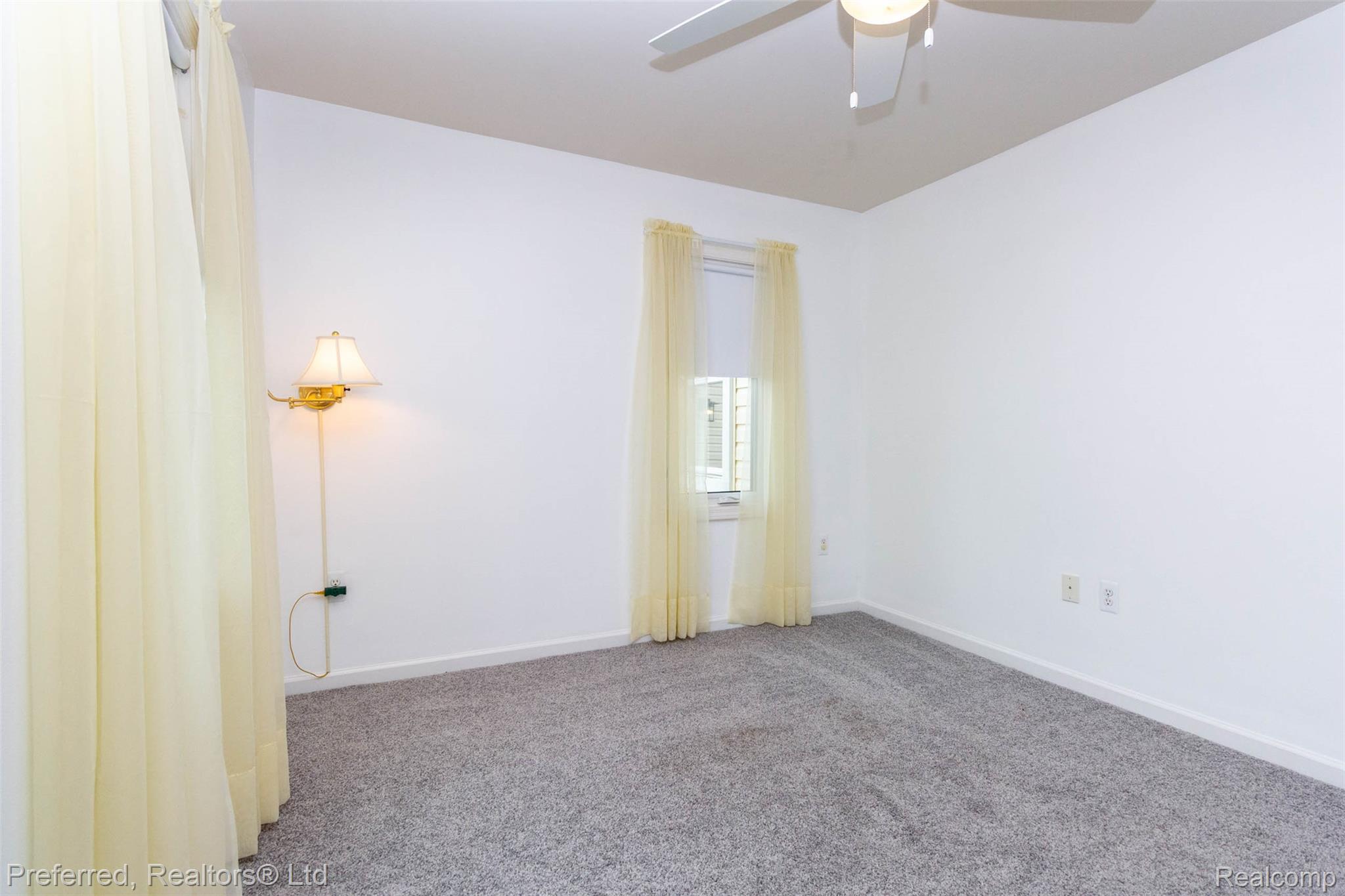 9840 Currie Road Northville, MI 48167 - Photo 27 of 62 Empty room featuring carpet floors and a ceiling fan