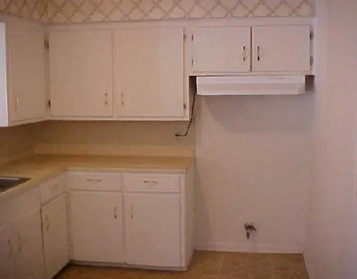 a view of cabinets and wooden floor