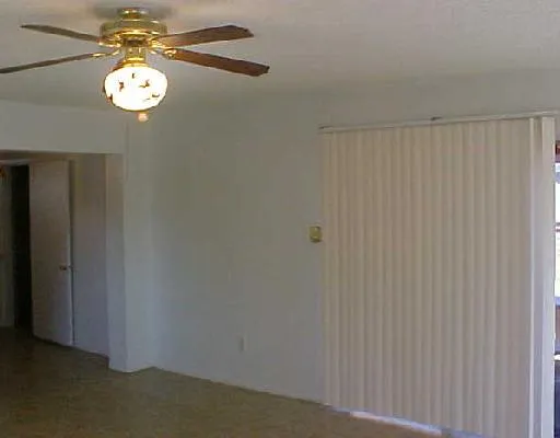a view of a chandelier fan and closet in a room