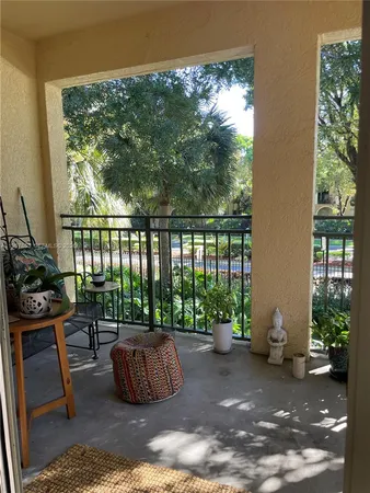 a building outdoor space with patio furniture and potted plants