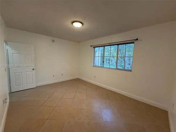 an empty room with a empty space and windows