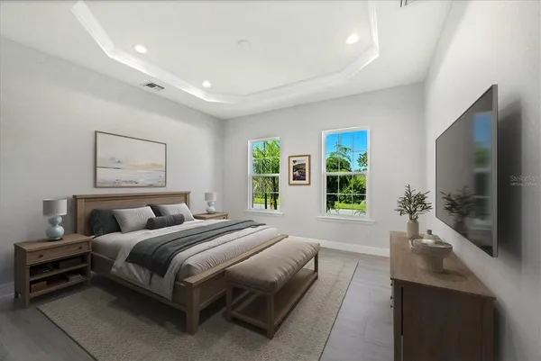 a spacious bedroom with a large bed and a flat screen tv