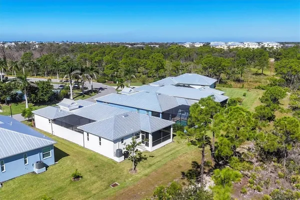 an aerial view of a house with a yard
