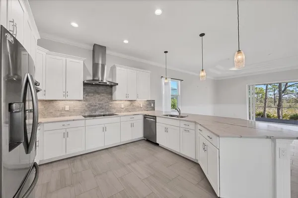 a kitchen with granite countertop white cabinets white stainless steel appliances and sink