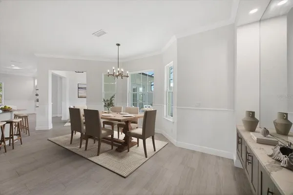 a view of a dining room with furniture and chandelier