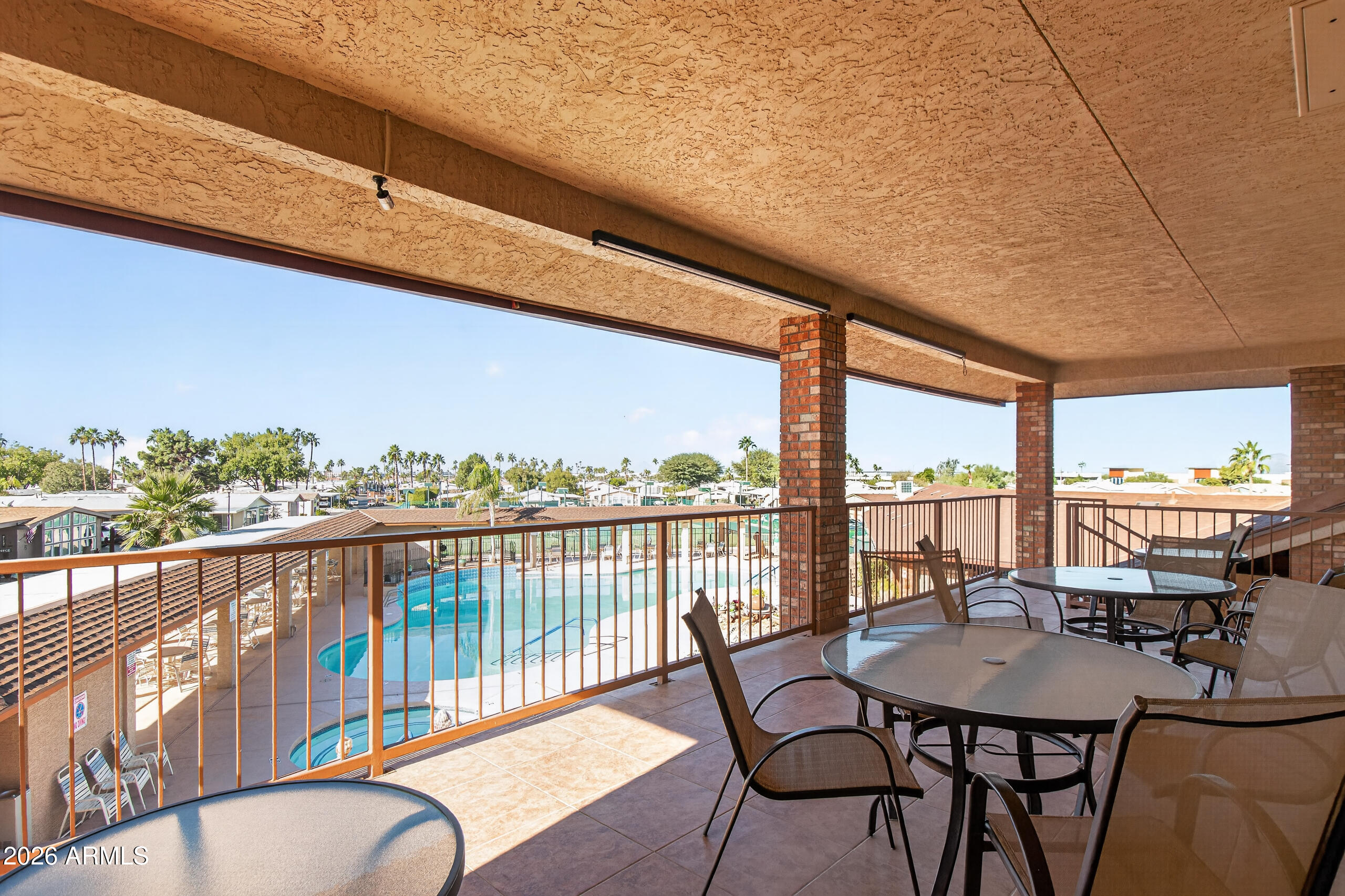 5735 East McDowell Road, Unit 293 Mesa, AZ 85215 - Photo 29 of 40 a view of a balcony with table and chairs