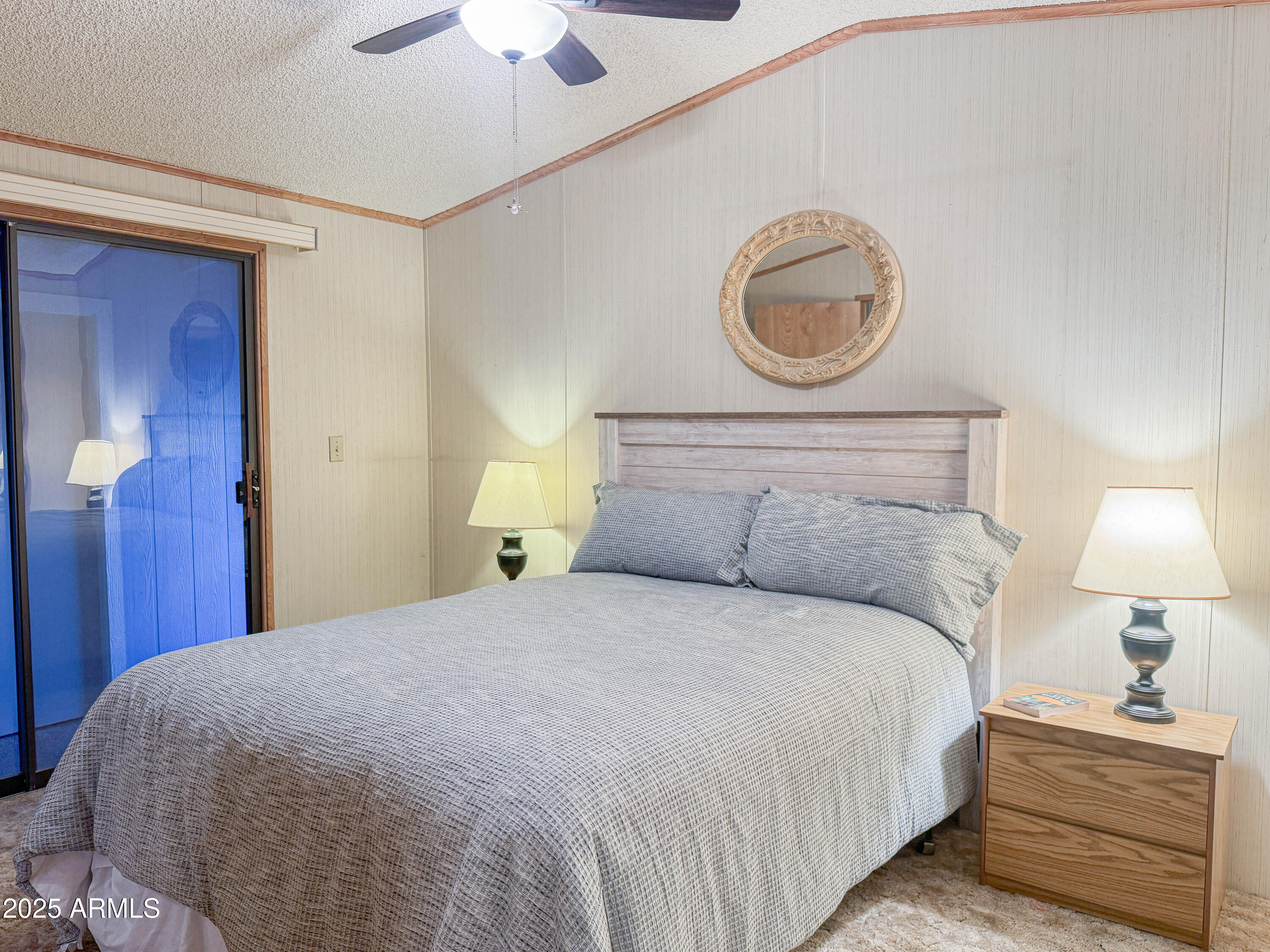 5735 East McDowell Road, Unit 293 Mesa, AZ 85215 - Photo 6 of 40 a bedroom with a bed and a chandelier