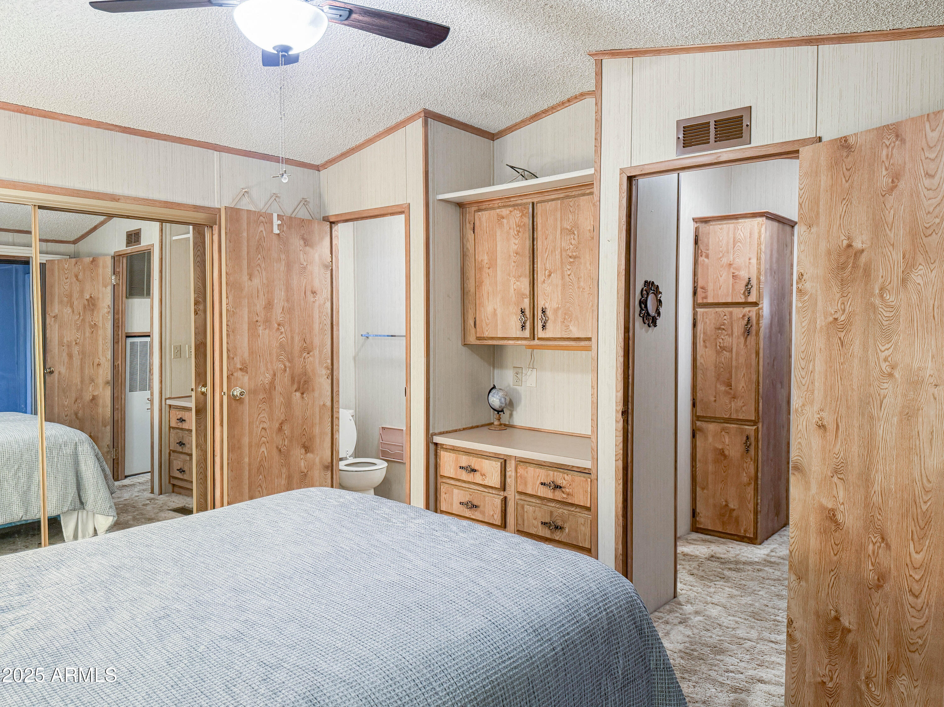 5735 East McDowell Road, Unit 293 Mesa, AZ 85215 - Photo 8 of 40 a spacious bedroom with a bed and a chandelier