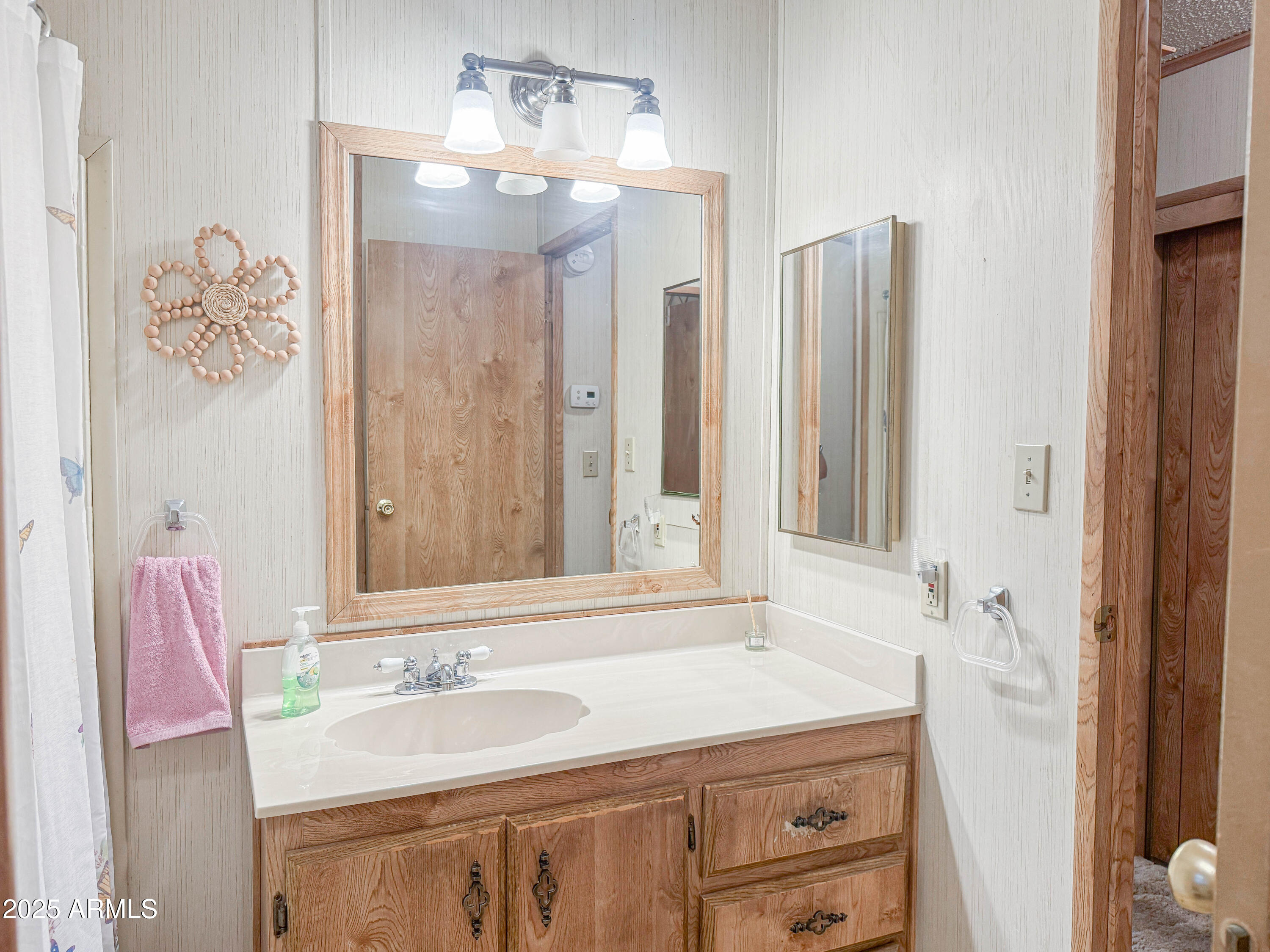 5735 East McDowell Road, Unit 293 Mesa, AZ 85215 - Photo 9 of 40 a bathroom with a sink and a mirror