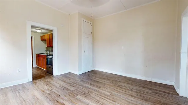 an empty room with wooden floor and closet