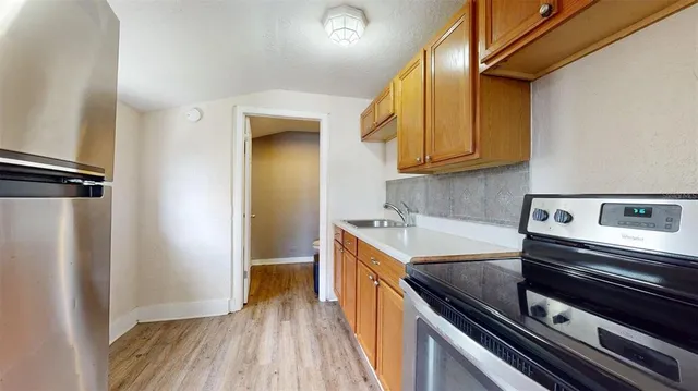 a kitchen with a sink stove and cabinets
