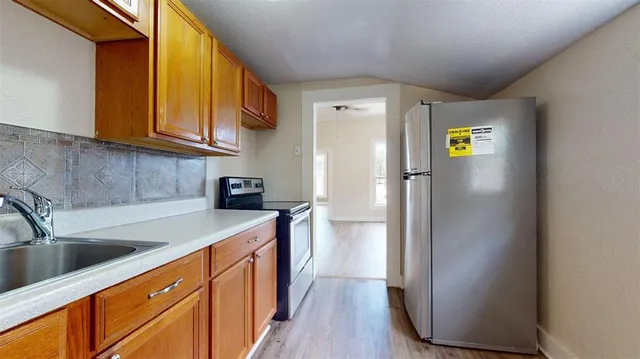 a kitchen with a sink cabinets and stainless steel appliances