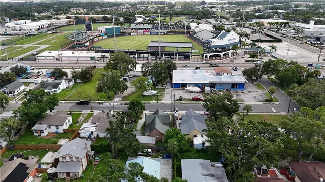 an aerial view of residential houses with outdoor space and swimming pool