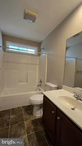 a bathroom with a sink a toilet and a bathtub