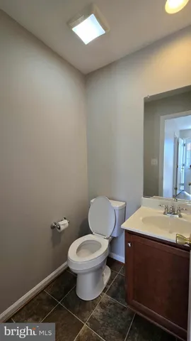 a white toilet sitting next to a bathroom sink