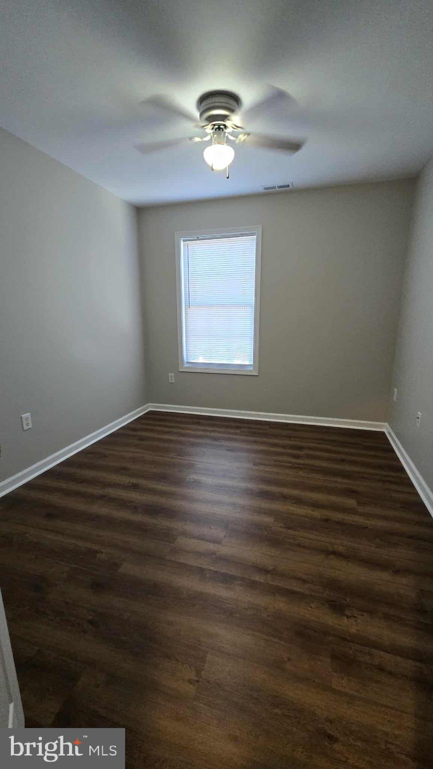 511 National Avenue Winchester, VA 22601 - Photo 7 of 10 an empty room with wooden floor and windows