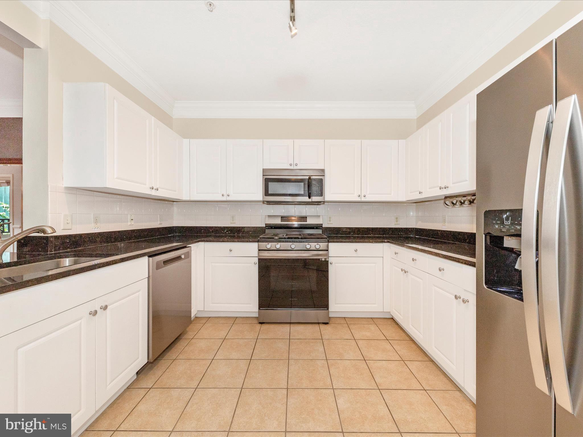 7 Booth Street, Unit 201 Gaithersburg, MD 20878 - Photo 11 of 67 a kitchen with granite countertop a refrigerator stove and sink