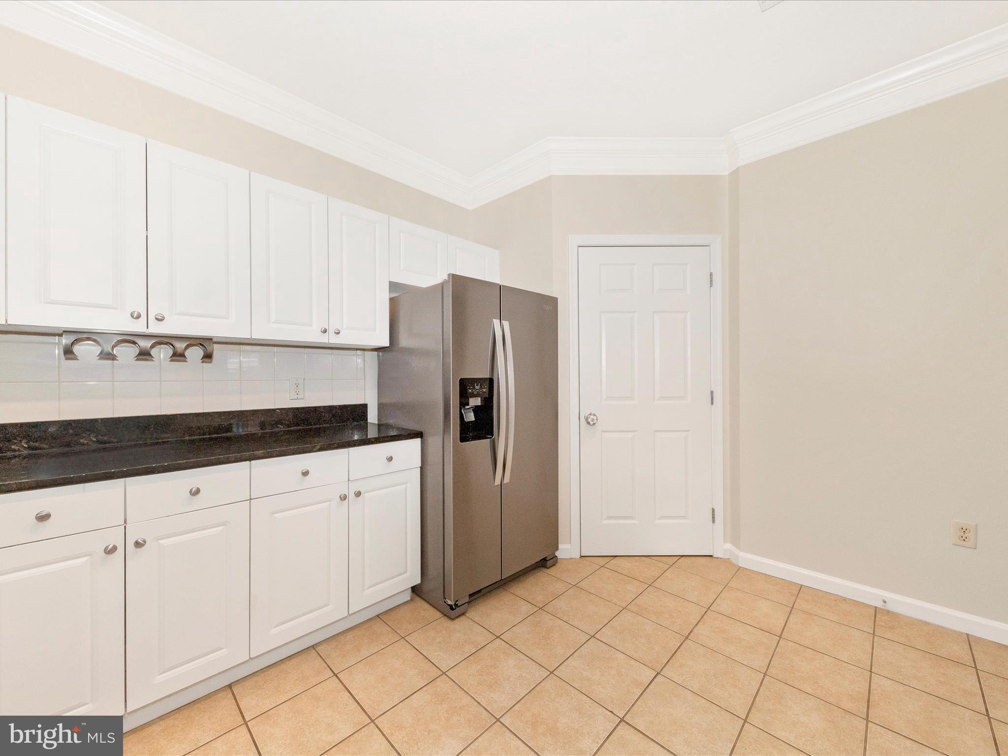 7 Booth Street, Unit 201 Gaithersburg, MD 20878 - Photo 12 of 67 a kitchen with granite countertop white cabinets and stainless steel appliances